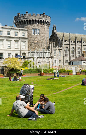 Ireland, Dublin, Dublin Castle, visitors on Dubhlinn Gardens lawn below Record Tower Stock Photo
