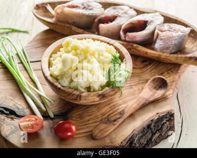 Mashed potatoes in the wooden bowl on the service tray. Stock Photo