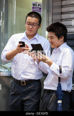 Tokyo, Japan. 22nd July, 2016. Fans try out Pokemon Go in Tokyo's Shibuya district on July 22, 2016, Tokyo, Japan. The Pokemon Go app finally arrived in the land of the Pokemon on Friday 22, July two weeks after its launch in the United States. The release of the app in Japan had been rumoured for the past few days after the leak of details of a partnership deal with McDonald's Japan to create Pokemon Gyms in its 3,000 locations. Nintendo's market value has almost doubled since the app created by Niantic first launched in America. Credit:  Aflo Co. Ltd./Alamy Live News Stock Photo