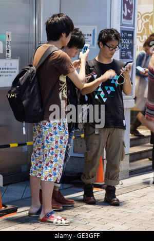 Tokyo, Japan. 22nd July, 2016. Fans try out Pokemon Go in Tokyo's Shibuya district on July 22, 2016, Tokyo, Japan. The Pokemon Go app finally arrived in the land of the Pokemon on Friday 22, July two weeks after its launch in the United States. The release of the app in Japan had been rumoured for the past few days after the leak of details of a partnership deal with McDonald's Japan to create Pokemon Gyms in its 3,000 locations. Nintendo's market value has almost doubled since the app created by Niantic first launched in America. Credit:  Aflo Co. Ltd./Alamy Live News Stock Photo