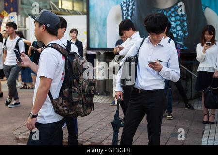 Tokyo, Japan. 22nd July, 2016. Fans try out Pokemon Go in Tokyo's Shibuya district on July 22, 2016, Tokyo, Japan. The Pokemon Go app finally arrived in the land of the Pokemon on Friday 22, July two weeks after its launch in the United States. The release of the app in Japan had been rumoured for the past few days after the leak of details of a partnership deal with McDonald's Japan to create Pokemon Gyms in its 3,000 locations. Nintendo's market value has almost doubled since the app created by Niantic first launched in America. Credit:  Aflo Co. Ltd./Alamy Live News Stock Photo