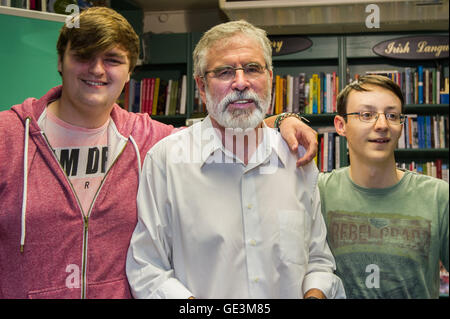 Cork, Ireland. 22nd July, 2016. Gerry Adams, the President of Political Party Sinn Féin was in Liam Ruiseal's Bookshop in Oliver Plunkett Street, Cork, on Friday 22nd July, signing his new book - 'My Little Book of Tweets'. Stephen Kingsley and Conor O'Carroll, both from Ballincollig, got their copy of the book signed by Mr Adams. Credit: Andy Gibson/Alamy Live News. Stock Photo