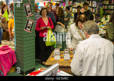 Cork, Ireland. 22nd July, 2016. A big crowd turned out to see Gerry Adams, the President of Political Party Sinn Féin sign his new book - 'My Little Book of Tweets' in Liam Ruiseal's Bookshop in Oliver Plunkett Street, Cork, on Friday 22nd July. Credit: Andy Gibson/Alamy Live News. Stock Photo