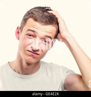 Young man with headache touching forehead. Toned photo. Stock Photo