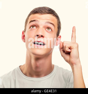 Young man showing upwards index finger. Toned photo. Stock Photo