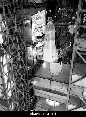 The Apollo Command/Service Module 103 is being integrated with the Instrument Unit atop the Saturn V rocket inside the Vehicle Assembly Building (VAB) at Kennedy Space Center. This assembly was part of the preparations for Apollo missions. Stock Photo