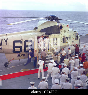 (December 27, 1968) The Apollo 8 crew stands in the doorway of a recovery helicopter after arriving aboard the carrier U.S.S. Yorktown, recovery vessel for the historic initial manned lunar orbital mission. In left foreground is astronaut Frank Borman, Mission Commander. Behind Borman is astronaut James A. Lovell Jr., Command Module pilot; and on the right is astronaut William A. Anders, Lunar Module pilot. Apollo 8 splashed down at 10:51 a.m. (EST), December 27, 1968, in the central Pacific Ocean, approximately 1,000 miles south-southwest of Hawaii.   Image # : S68-56326 Stock Photo