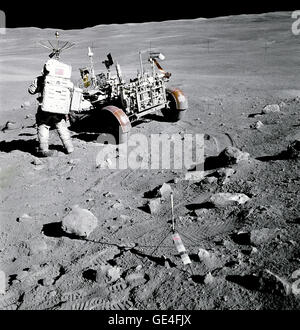 Apollo 16 astronaut Charles M. Duke Jr., pilot of the Lunar Module &quot;Orion&quot;, stands near the Rover, Lunar Roving Vehicle (LRV) at Station no. 4, near Stone Mountain, during the second Apollo 16 extravehicular activity (EVA-2) at the Descartes landing site. Light rays from South Ray crater can be seen at upper left. The gnomon, which is used as a photographic reference to establish local vertical Sun angle, scale, and lunar color, is deployed in the center foreground. Note angularity of rocks in the area.   Image # : AS16-107-17446 Stock Photo