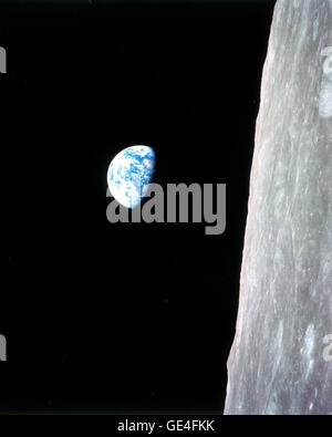 (December 24, 1968) This view of the rising Earth greeted the Apollo 8 astronauts on December 24, 1968 as they came from behind the Moon after the fourth nearside orbit. The photo is displayed here in its original orientation, though it is more commonly viewed with the lunar surface at the bottom of the photo. Earth is about five degrees left of the horizon in the photo. The unnamed surface features on the left are near the eastern limb of the Moon as viewed from Earth. The lunar horizon is approximately 780 kilometers from the spacecraft. Height of the photographed area at the lunar horizon i Stock Photo