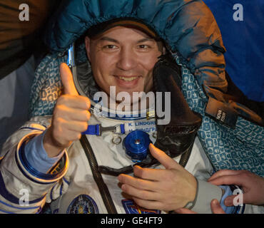 NASA Astronaut Kjell Lindgren rests in a chair just minutes after he and Kimya Yui of the Japan Aerospace Exploration Agency (JAXA) and Oleg Kononenko of the Russian Federal Space Agency (Roscosmos) landed in their Soyuz TMA-17M spacecraft  in a remote area near the town of Zhezkazgan, Kazakhstan on Friday, December 11, 2015. Kononenko, Lindgren, and Yui returned after 141 days in space where they served as members of the Expedition 44 and 45 crews onboard the International Space Station. Photo Credit: (NASA/GCTC/Andrey Shelepin)  Image #: Date: December 11, 2015 Stock Photo