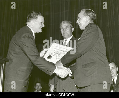(October 15, 1964) NASA Administrator James E. Webb presents the Group Achievement Award to Kennedy Space Center Director Dr. Kurt Debus, for Kennedy Space Center's role in the successful launch of the Saturn I rocket. Stock Photo