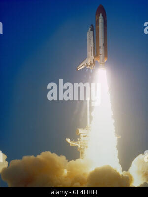 (April 5, 1984) View of the launch of the Shuttle Challenger during the STS 41-C mission. The orbiter has cleared the launch pad with a large cloud of smoke covering the bottom part of the frame. Stock Photo