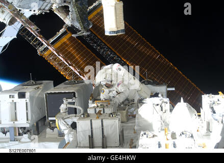 (July 22, 2009) Astronaut Christopher Cassidy, STS-127 mission specialist, is pictured in the center of this wide shot photographed during Endeavour's third space walk of a scheduled five overall for this flight. Cassidy is near The Japanese Experiment Module - Exposed Facility (JEF.) This was Cassidy's first of a scheduled three sessions for him. Astronaut Dave Wolf, Cassidy's EVA colleague, is out of frame.  STS-127 launched on Space Shuttle Endeavor on July 15, 2009. The mission ended on July 31, 2009.   Image # : S127-E-007801 Stock Photo