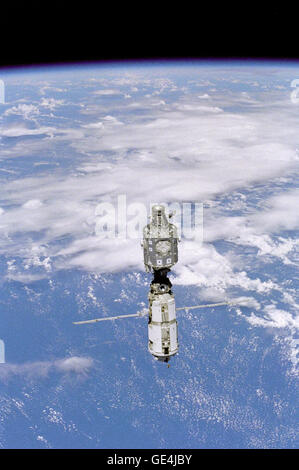 Backdropped against white clouds and blue ocean waters, the International Space Station (ISS) moves away from the Space Shuttle Discovery. The U.S.- built Unity node (top) and the Russian-built Zarya or FGB module (with the solar array panels deployed) were joined during a December 1998 mission. A portion of the work performed on the May 30 space walk by astronauts Tamara E. Jernigan and Daniel T. Barry is evident at various points on the ISS, including the installation of the Russian-built crane (called Strela).   Image # : STS096-333-021  Date: June 3, 1999