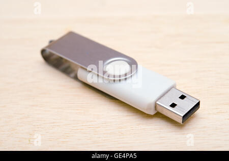 USB stick or USB thumb drive isolated on wooden board Stock Photo