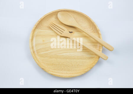 wooden plate with spoon fork top view on white background Stock Photo
