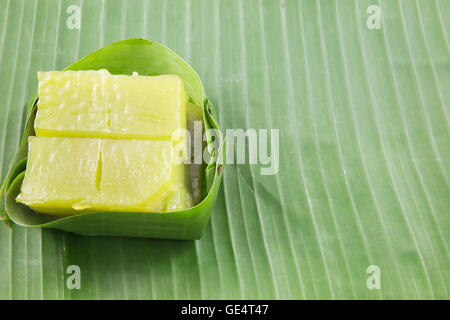 Kind of Thai sweetmeat, Multi Layer Sweet Cake (Kanom Chan) on banana leaf with orchid flower Stock Photo