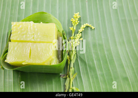 Kind of Thai sweetmeat, Multi Layer Sweet Cake (Kanom Chan) on banana leaf with flower Stock Photo