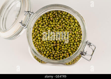 Jar with open lid full of soy beans Stock Photo