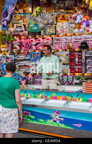 Toys on display as prizes at Hook-a-duck / Duck Pond Game, traditional fairground stall game at travelling funfair Stock Photo