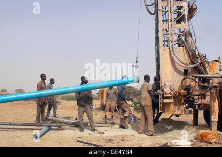 In Africa water is in-depth, it is necessary to make a drilling. Installation of a piece of pipe Stock Photo