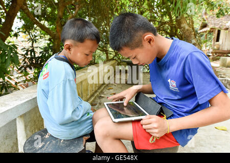 Boys with a tablet Laos Stock Photo