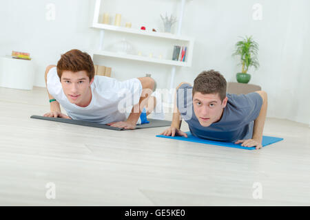 Two men doing push-ups Stock Photo