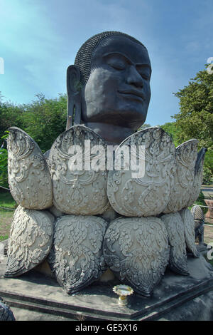 Black Buddha head and lotus statue in Wat Tam Migarat (Local name of the temple) in Ayuthaya, Thailand Stock Photo