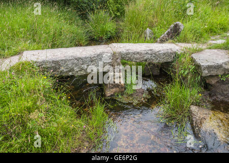 Example of a small clapper bridge over Gawler Brook, north of the Dartmoor National Park Visitor Centre at Postbridge, Devon. Stock Photo
