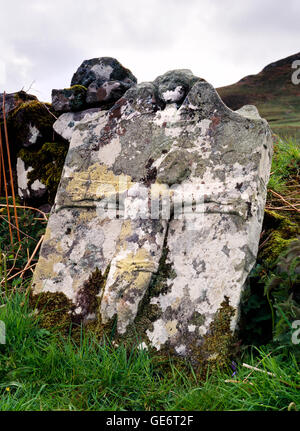 Lichen covered 18th century headstone depicting crucified Christ and cherub, Campbell burial ground, Camas nan Geall Stock Photo