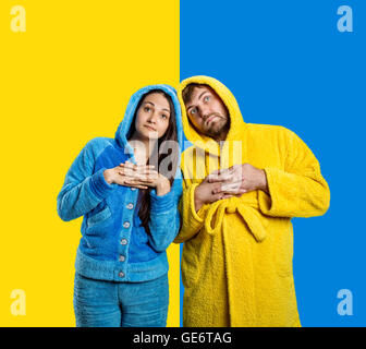 Couple wearing blue pijamas and yellow bathrobe Stock Photo