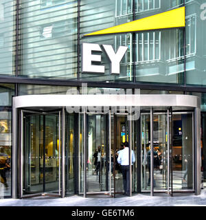 London office revolving door entrance with Ernst & Young logo & sign above for multinational professional services firm in Southwark London England UK Stock Photo