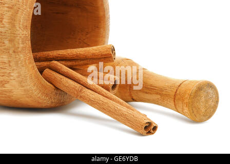 mortar and pestle with cinnamon sticks Stock Photo