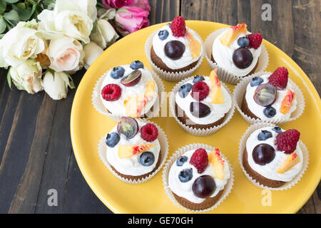 Refreshing Fruit Cupcakes  on a Yellow Plate. Stock Photo