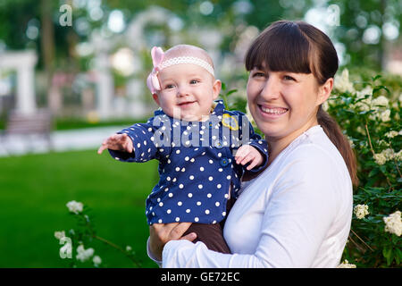 mom and little daughter walking in the park Stock Photo