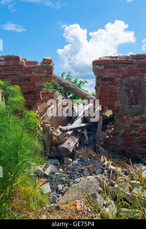 broken beams of a collapsed roof in abandoned building Stock Photo
