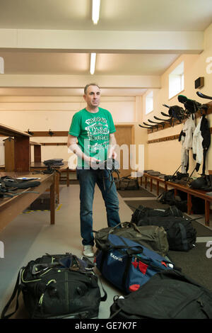 horse racing locker room, stud room where the jockeys change into their outfits with a locker room attendant and saddles Stock Photo