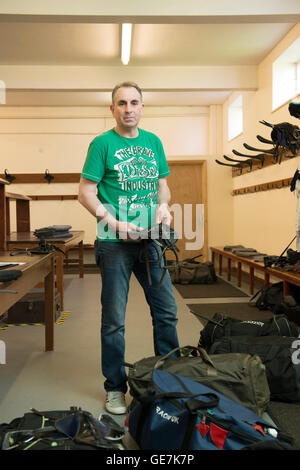 horse racing locker room, stud room where the jockeys change into their outfits with a locker room attendant and saddles Stock Photo