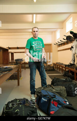 horse racing locker room, stud room where the jockeys change into their outfits with a locker room attendant and saddles Stock Photo