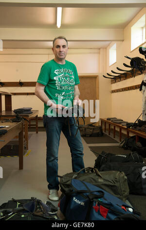 horse racing locker room, stud room where the jockeys change into their outfits with a locker room attendant and saddles Stock Photo