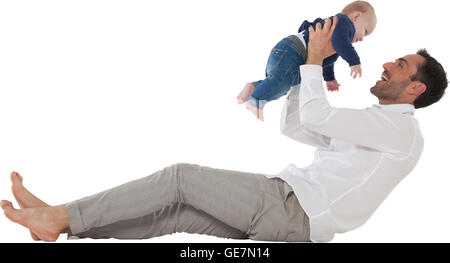 Full length of happy father playing with baby boy Young man with son spending leisure time Both are in casuals isolated over whi Stock Photo
