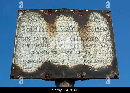 rusted british sign giving notice that, under the 1932 rights of way act, the public have no rights of way over adjacent land