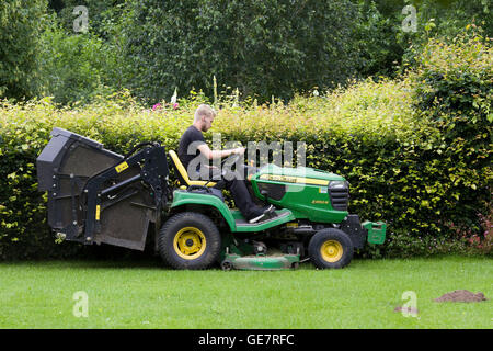 Man mowing the Lawns on a tractor lawn mower Stock Photo