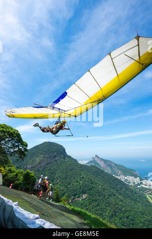 RIO DE JANEIRO - MARCH 22, 2016: A hang gliding instructor takes off with a passenger from the ramp at Pedra Bonita. Stock Photo