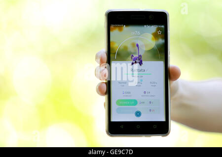 Sofia, Bulgaria - July 22, 2016: Woman holds in her hand a mobile phone showing on screen Pokemon Go augmented reality mobile ga Stock Photo