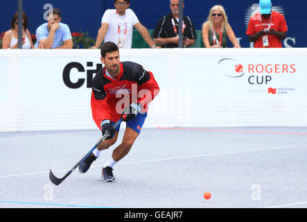 Toronto, Canada. 24th July, 2016. Serbian tennis player Novak Djokovic competes during a Ball Hockey Challenge game ahead of his 2016 Rogers Cup matches in Toronto, Canada, July 24, 2016. Credit:  Zou Zheng/Xinhua/Alamy Live News Stock Photo