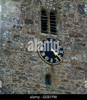 Saxon church at Buckland-in-the-moor with the famous clock face 'My Dear Mother' commissioned by the Whiteley family in memory Stock Photo