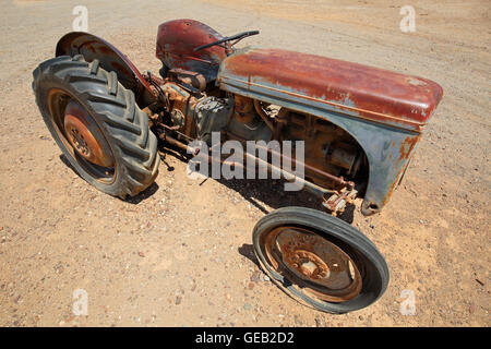 Rusty old tractor abandoned out in the field Stock Photo