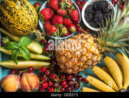 Healthy summer fruit variety. Sweet cherries, strawberries, blackberries, peaches, bananas, melon slices and mint leaves Stock Photo