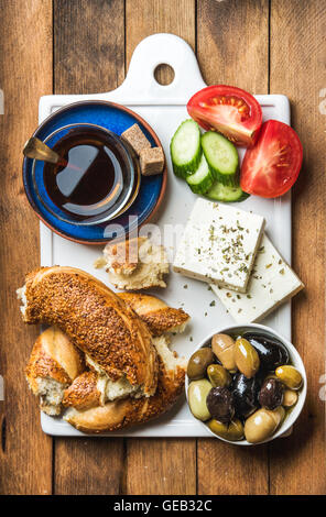 Turkish traditional breakfast with feta cheese, vegetables, olives, simit bagel and tea Stock Photo